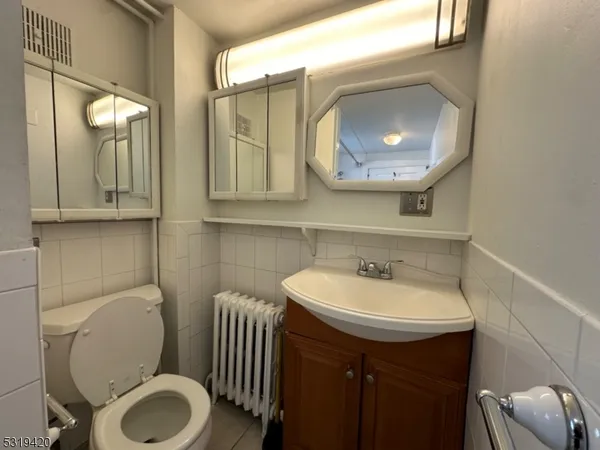 a bathroom with a toilet a sink and mirror