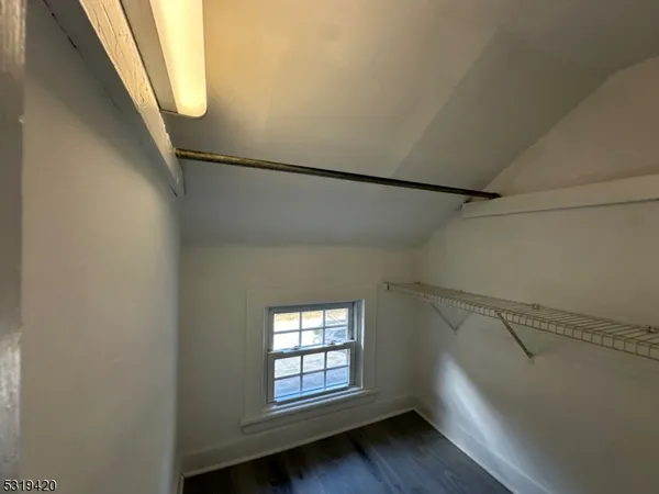 a view of entryway with window and wooden floor