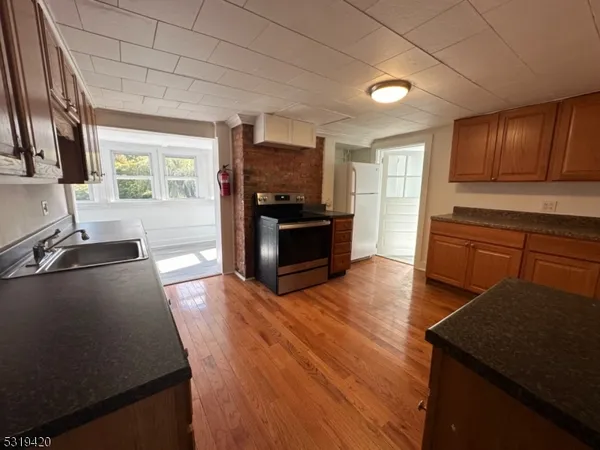 a kitchen with sink stove and refrigerator