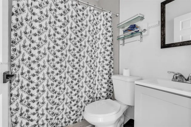 a white toilet sitting next to a bathroom sink