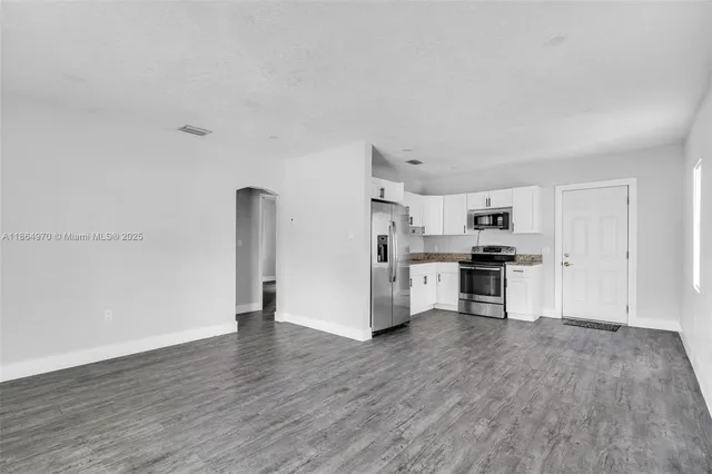a kitchen with stainless steel appliances a refrigerator and a stove top oven