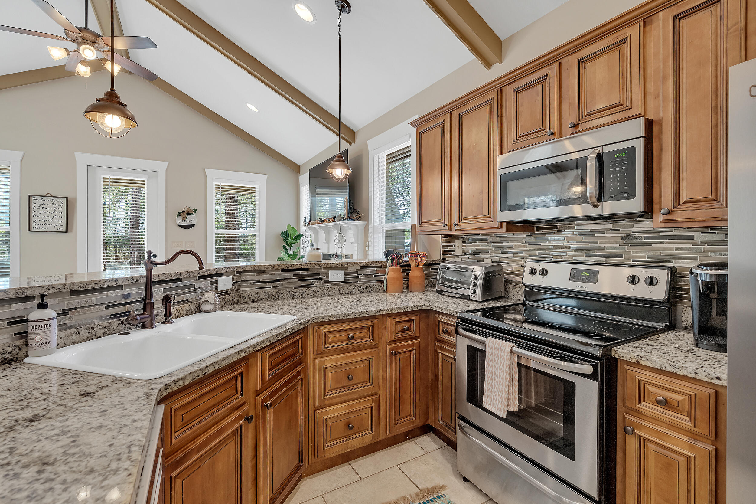 719 Earl Godwin Road Freeport, FL 32439 - Photo 12 of 23 a kitchen with stainless steel appliances granite countertop a sink stove and microwave