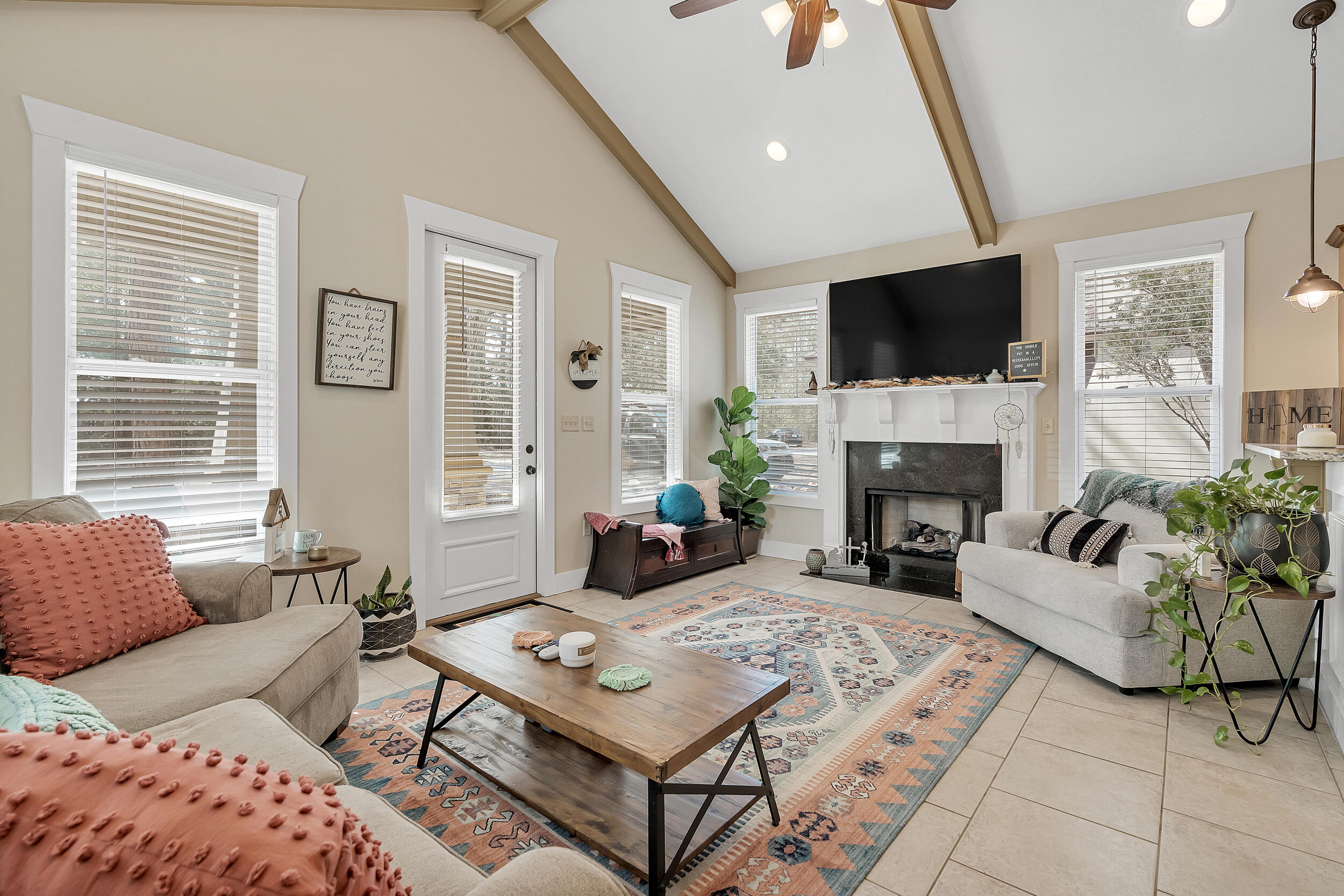 719 Earl Godwin Road Freeport, FL 32439 - Photo 7 of 23 a living room with furniture a flat screen tv and a fireplace