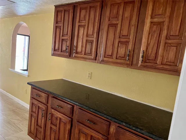a close view of a sink and cabinets