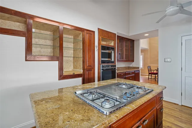 a kitchen with a wooden floor and cabinets
