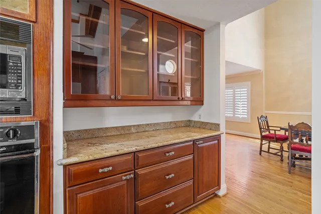 a kitchen with stainless steel appliances granite countertop a refrigerator a stove and a sink