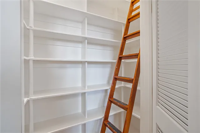 a dining room with furniture a chandelier and wooden floor
