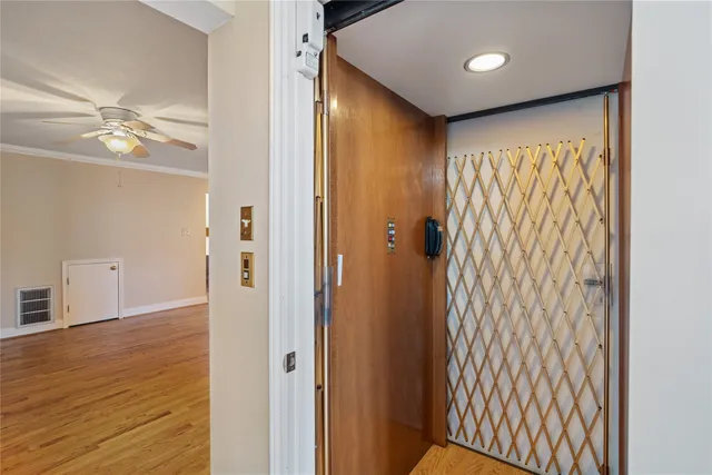 a view of a kitchen with wooden floor and a ceiling fan