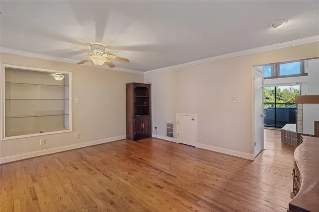 a view of a bedroom with a bed and wooden floor