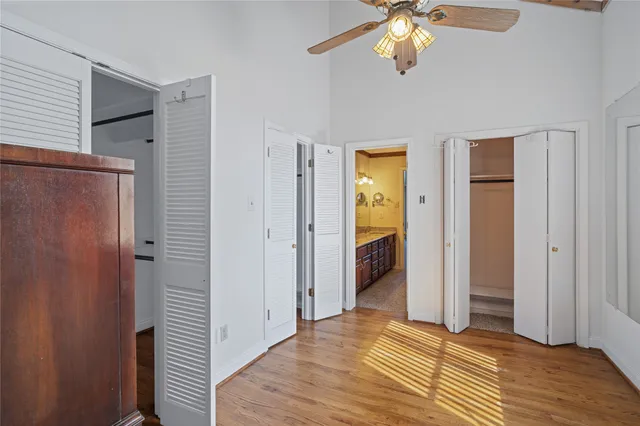 a bathroom with a granite countertop sink a large mirror and shower