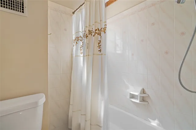 a view of a hallway with closet and cabinet
