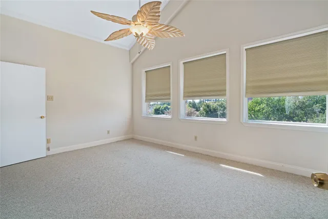 a view of staircase with lots of frames on wall and a window