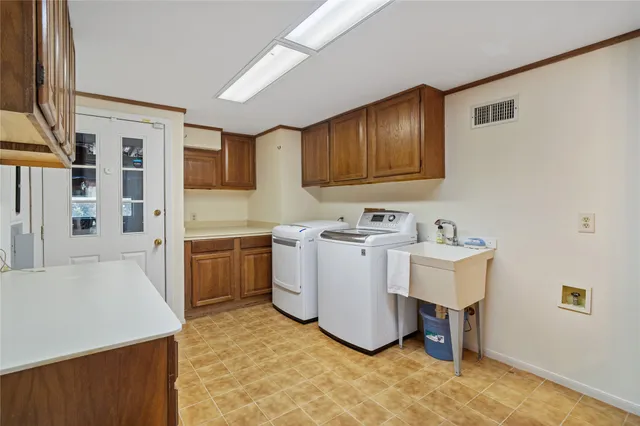 a utility room with a sink a washer and dryer