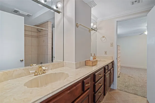 a bathroom with double sink and a mirror