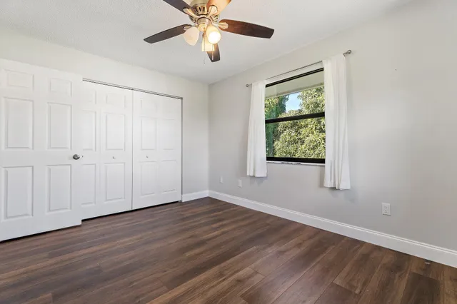 a view of a swimming pool with a yard and sitting area
