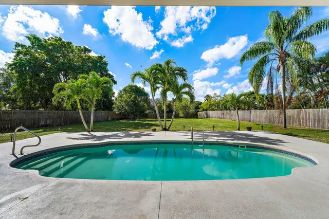 a view of a house with backyard and sitting area