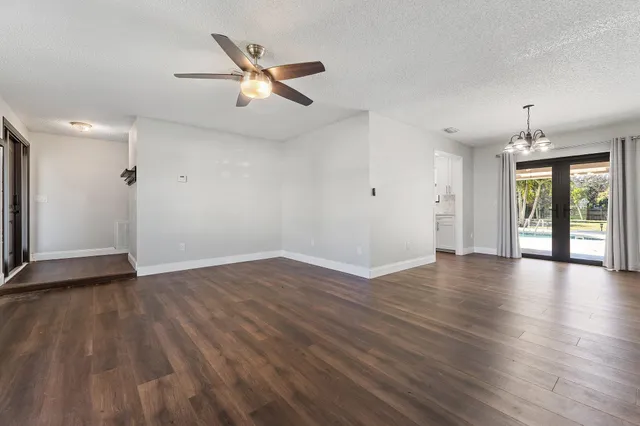 a view of a room with wooden floor and window