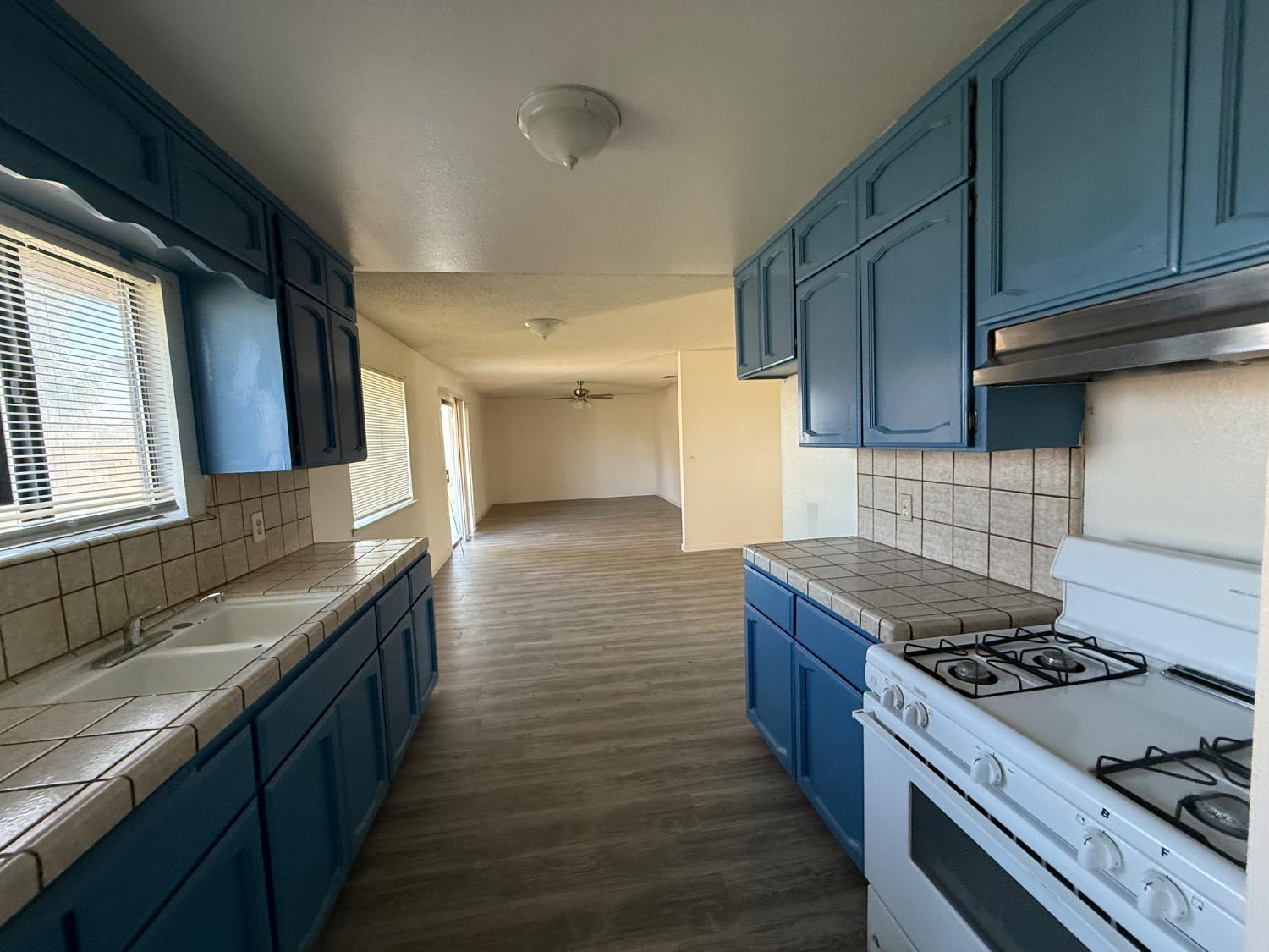 16385 North D Street Madera, CA 93638 - Photo 13 of 26 a kitchen with stainless steel appliances granite countertop a stove and a sink
