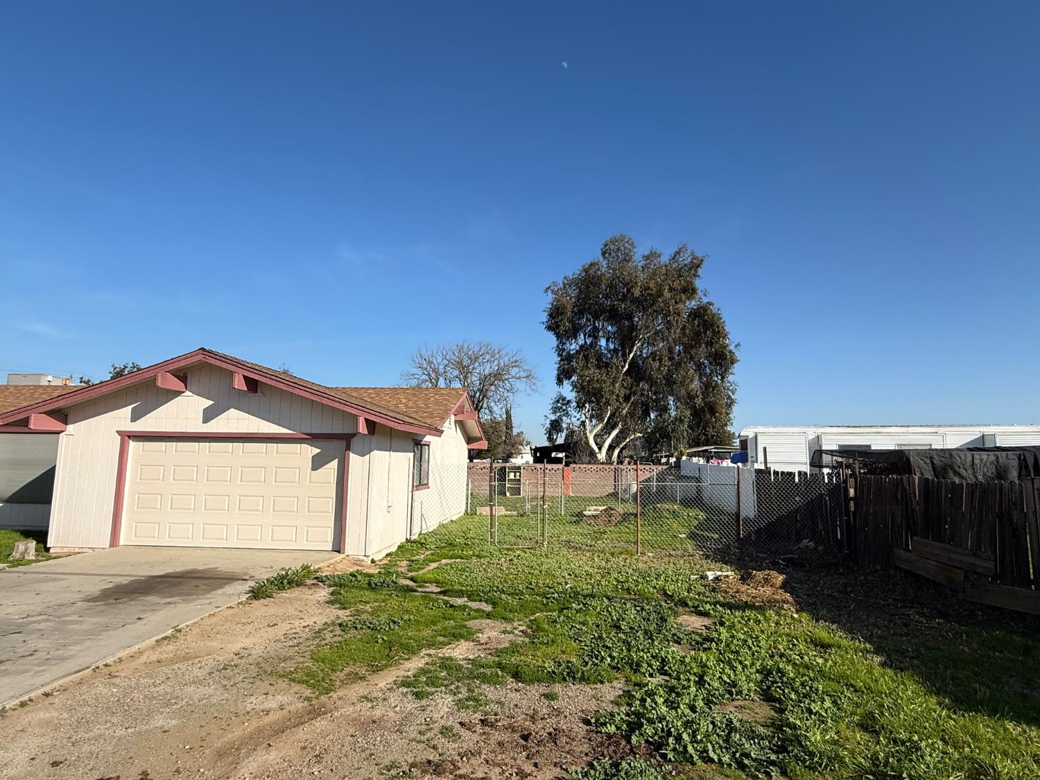 16385 North D Street Madera, CA 93638 - Photo 24 of 26 a front view of a house with a yard