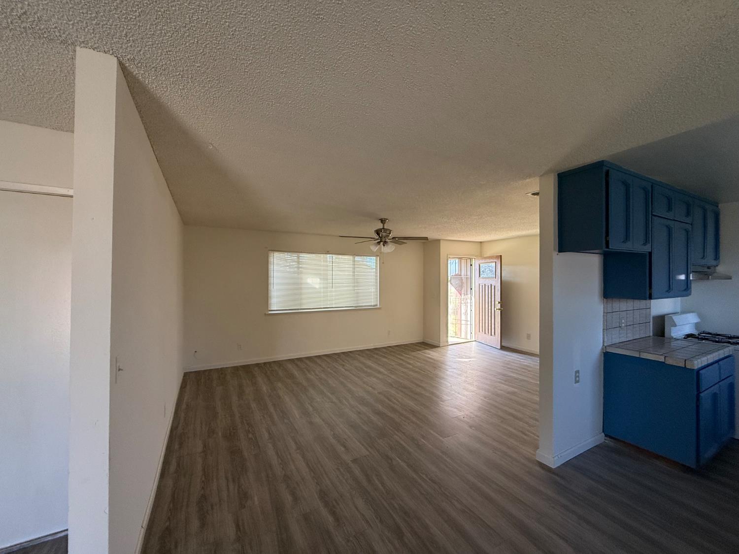 16385 North D Street Madera, CA 93638 - Photo 4 of 26 a view of empty room with wooden floor and window