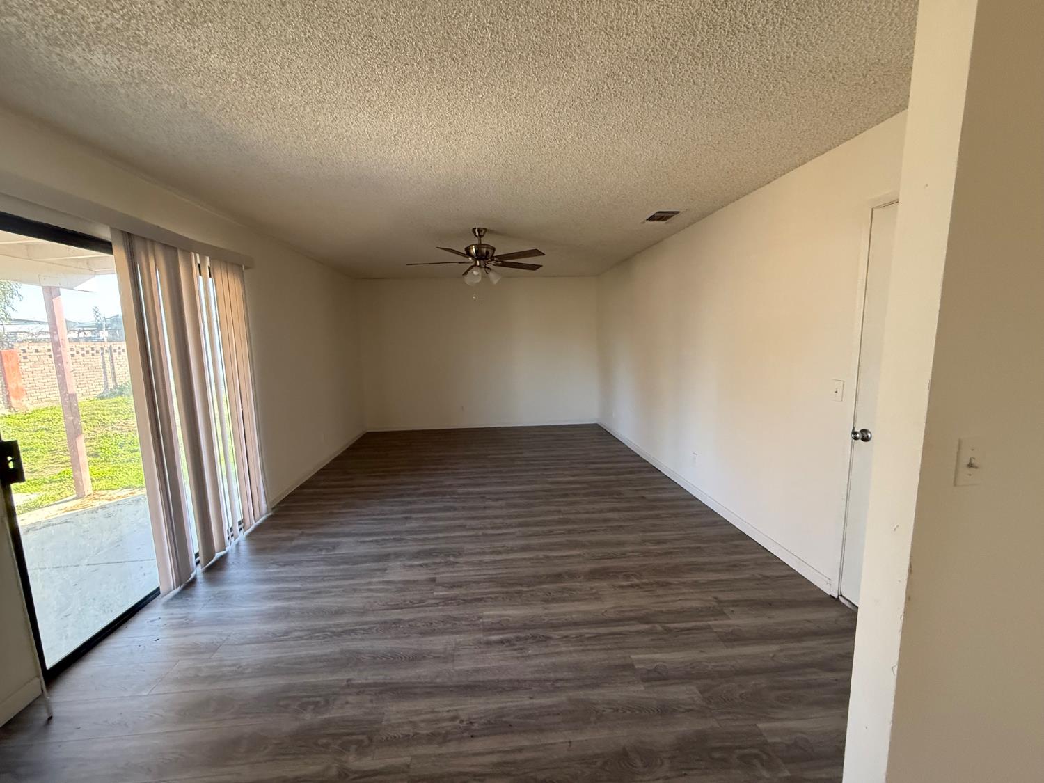 16385 North D Street Madera, CA 93638 - Photo 5 of 26 wooden floor in an empty room with a window