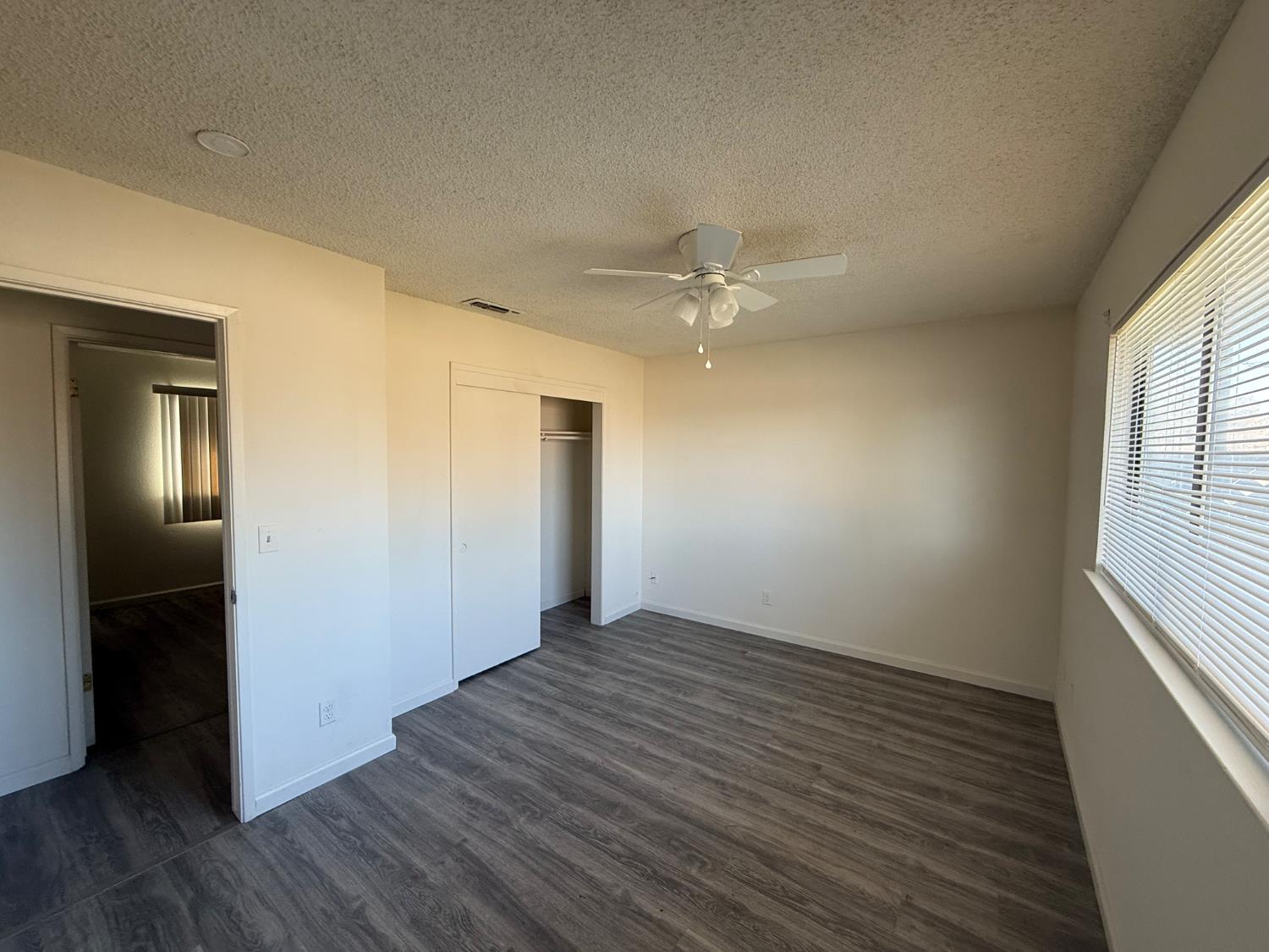 16385 North D Street Madera, CA 93638 - Photo 10 of 26 an empty room with wooden floor closet and windows
