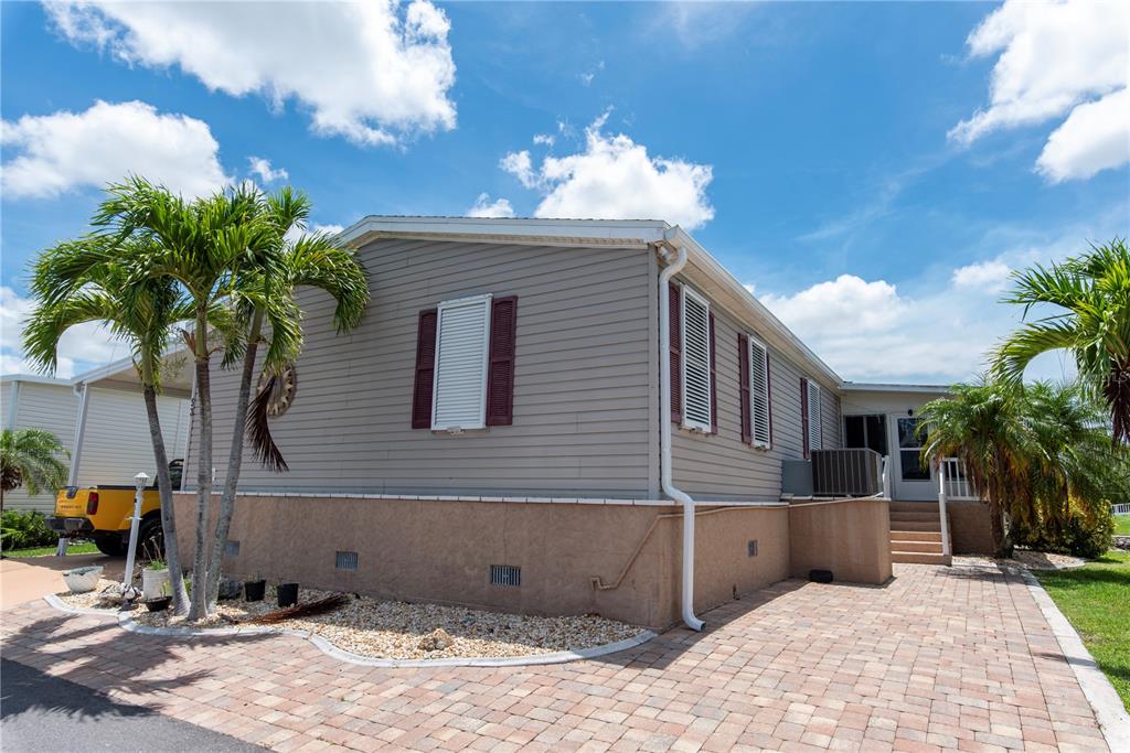 53 Rotterdam Punta Gorda, FL 33950 - Photo 2 of 26 a front view of a house with a yard and potted plants