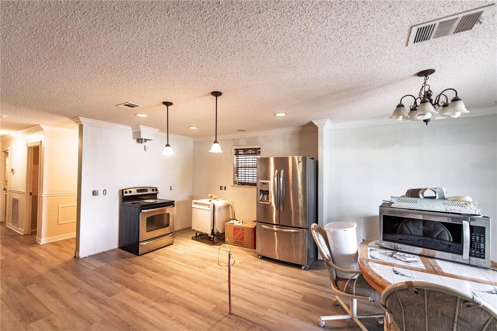 53 Rotterdam Punta Gorda, FL 33950 - Photo 5 of 26 a kitchen with granite countertop a stove a refrigerator and a fireplace