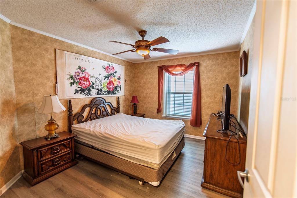 53 Rotterdam Punta Gorda, FL 33950 - Photo 10 of 26 a bed room with a bed and a chandelier