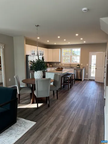 a view of a dining room with furniture wooden floor and chandelier