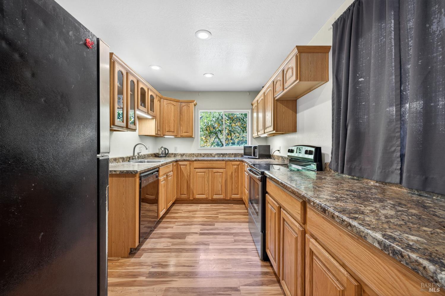 3320 Redwood Road Napa, CA 94558 - Photo 37 of 57 a kitchen with stainless steel appliances granite countertop a stove a sink and a refrigerator