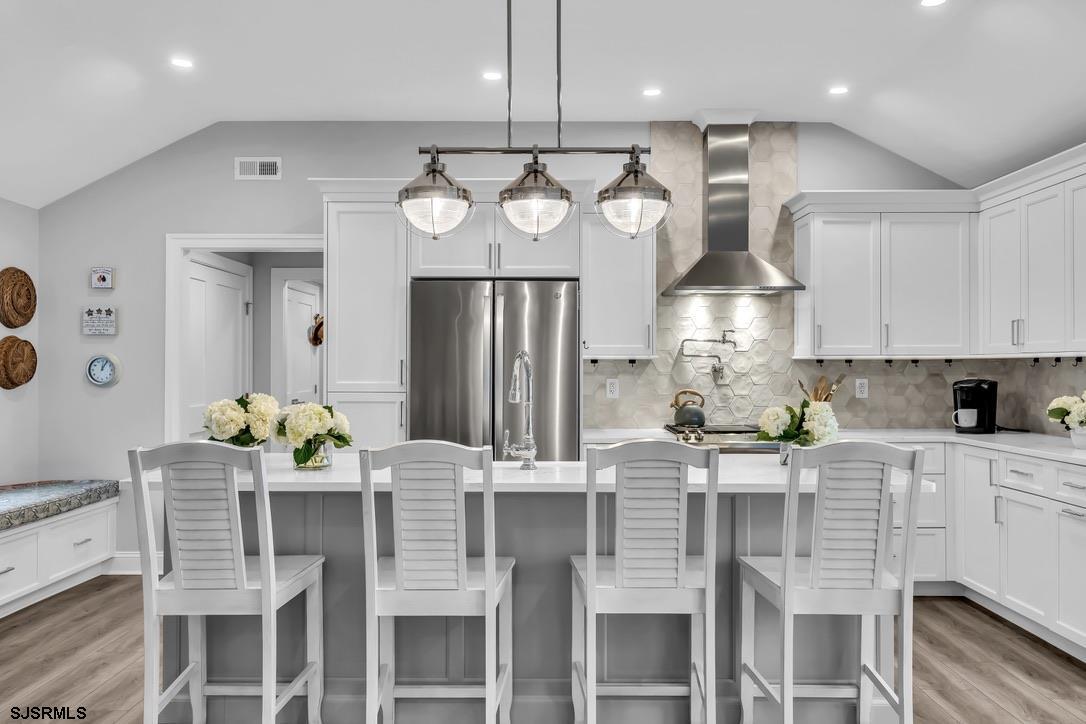1610 Shore Road Linwood, NJ 08221 - Photo 13 of 46 a kitchen with granite countertop a table chairs stove and refrigerator