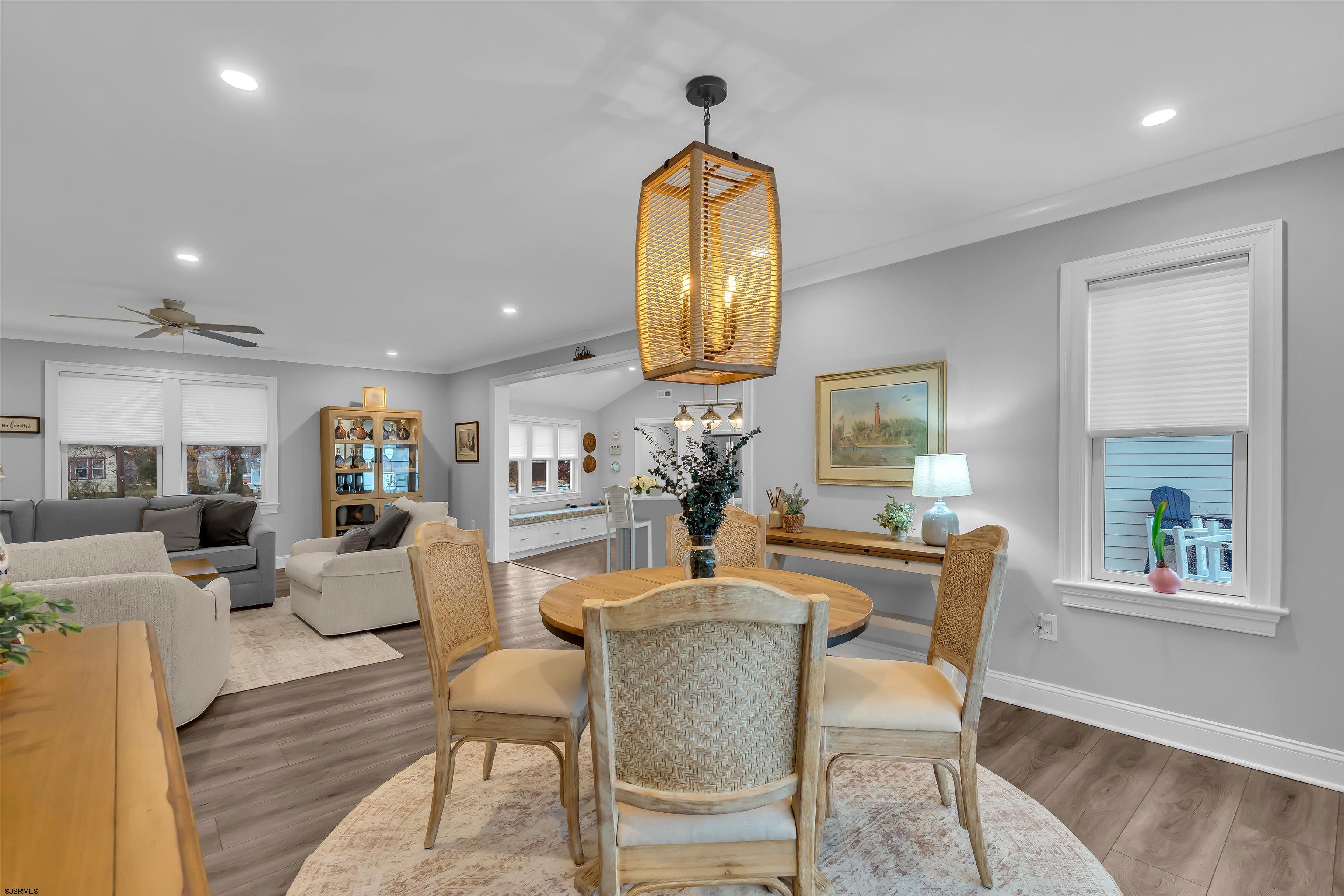 1610 Shore Road Linwood, NJ 08221 - Photo 20 of 46 a dining room with chandelier and wooden floor