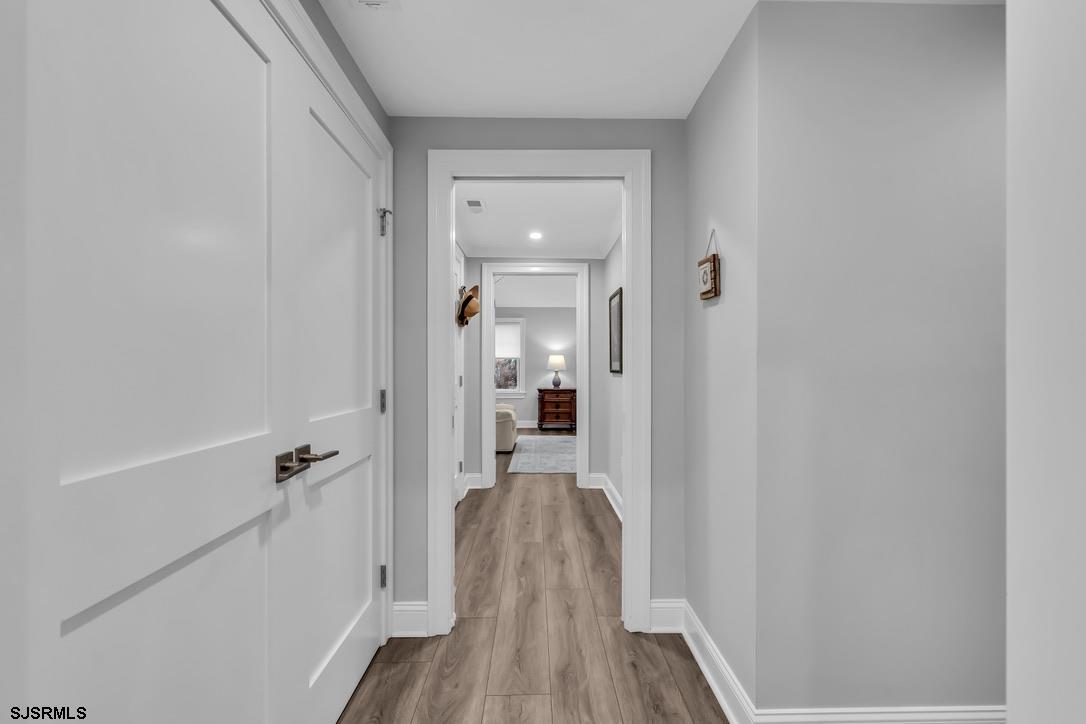 1610 Shore Road Linwood, NJ 08221 - Photo 32 of 46 a view of a hallway with wooden floor and staircase