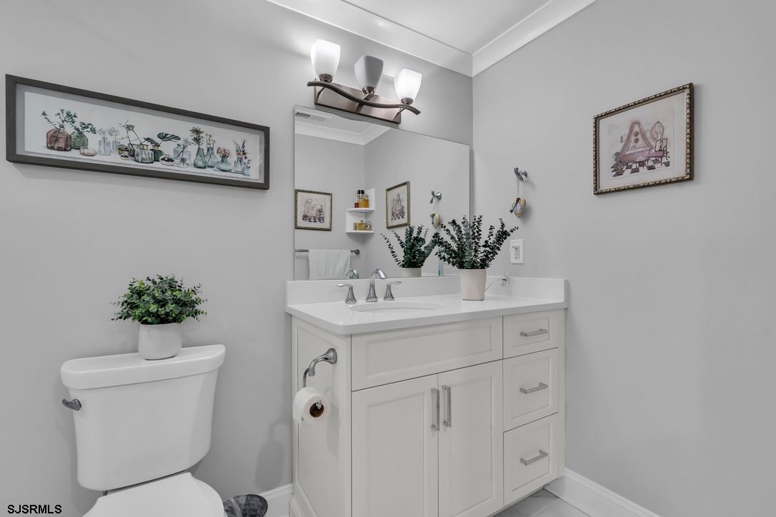 1610 Shore Road Linwood, NJ 08221 - Photo 36 of 46 a bathroom with a toilet sink and mirror