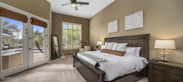 a bedroom with a bed a table and chair