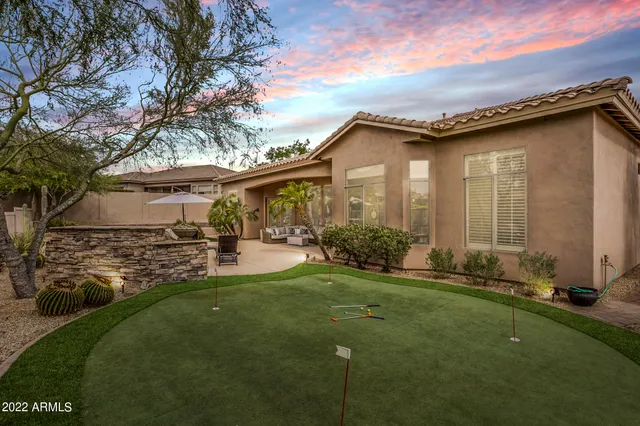 a front view of a house with a garden and patio