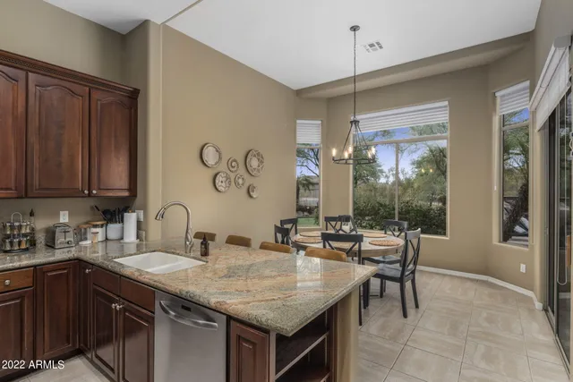 a kitchen with kitchen island a sink stove and refrigerator