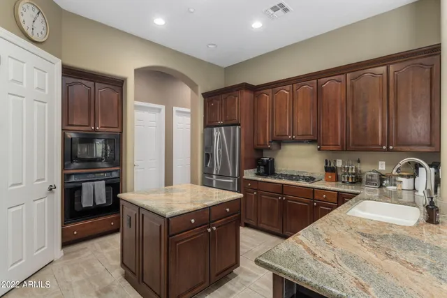 a kitchen with granite countertop a sink and a counter top space