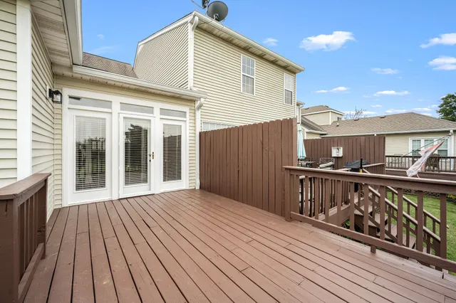 a view of a house with wooden deck