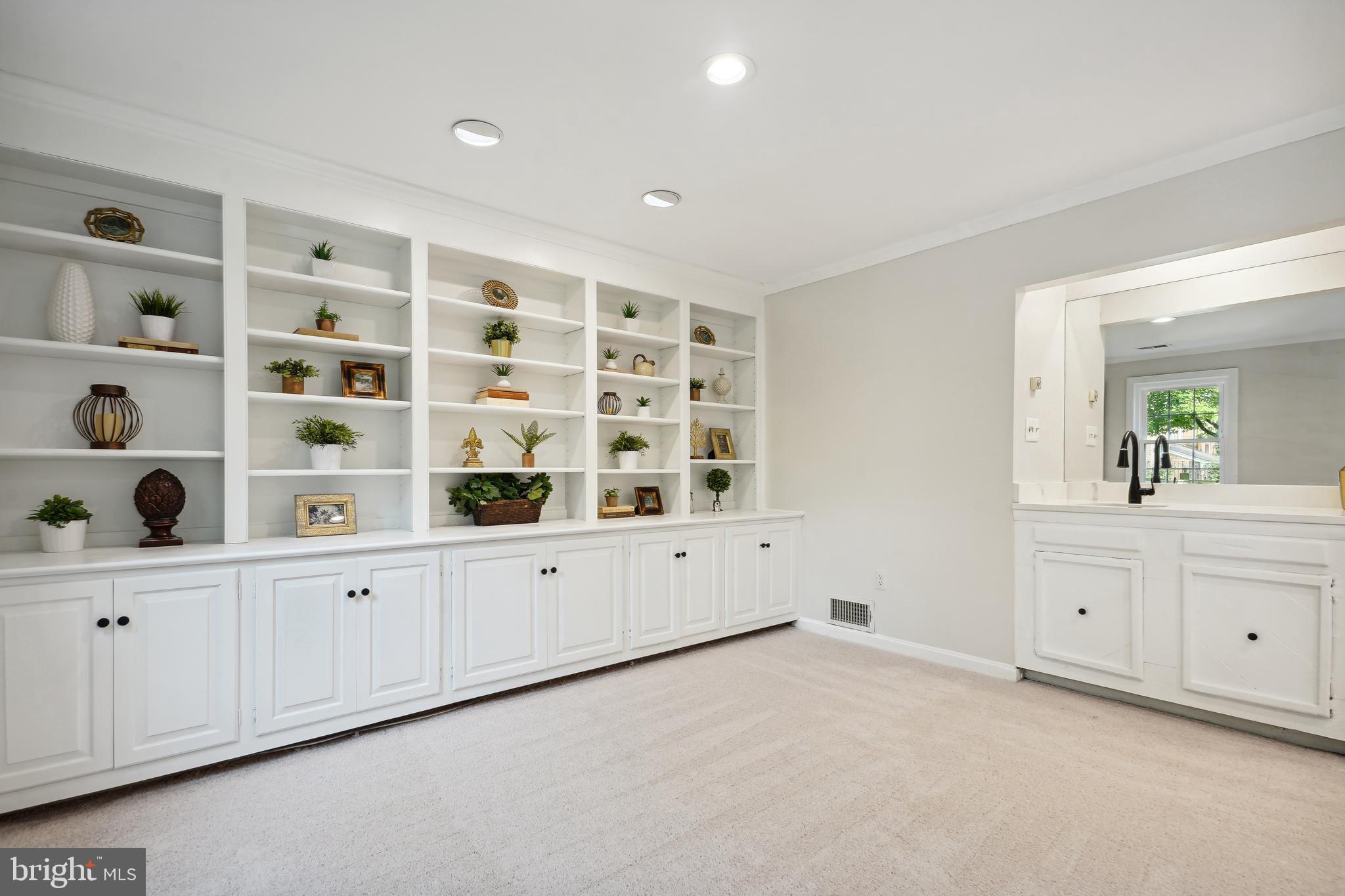 5809 Tudor Lane Rockville, MD 20852 - Photo 29 of 42 Lower Level Living Room - built-in bookshelve, bar