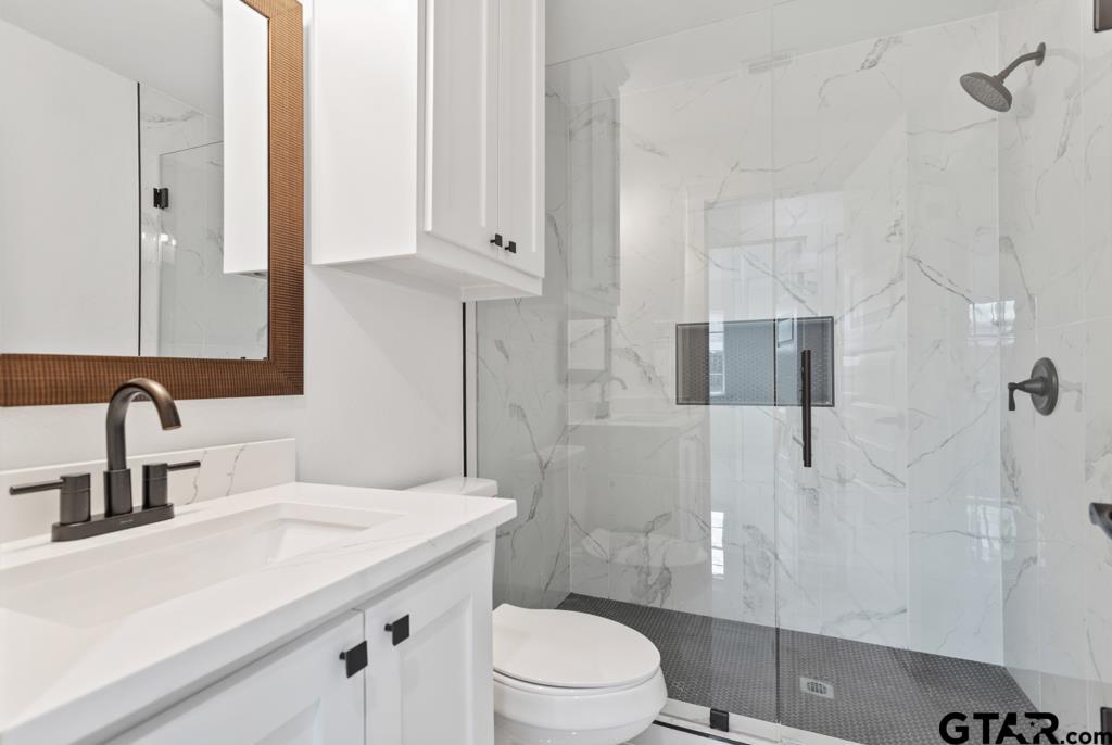 1608 Austin Drive Tyler, TX 75701 - Photo 19 of 36 a bathroom with a sink toilet and shower