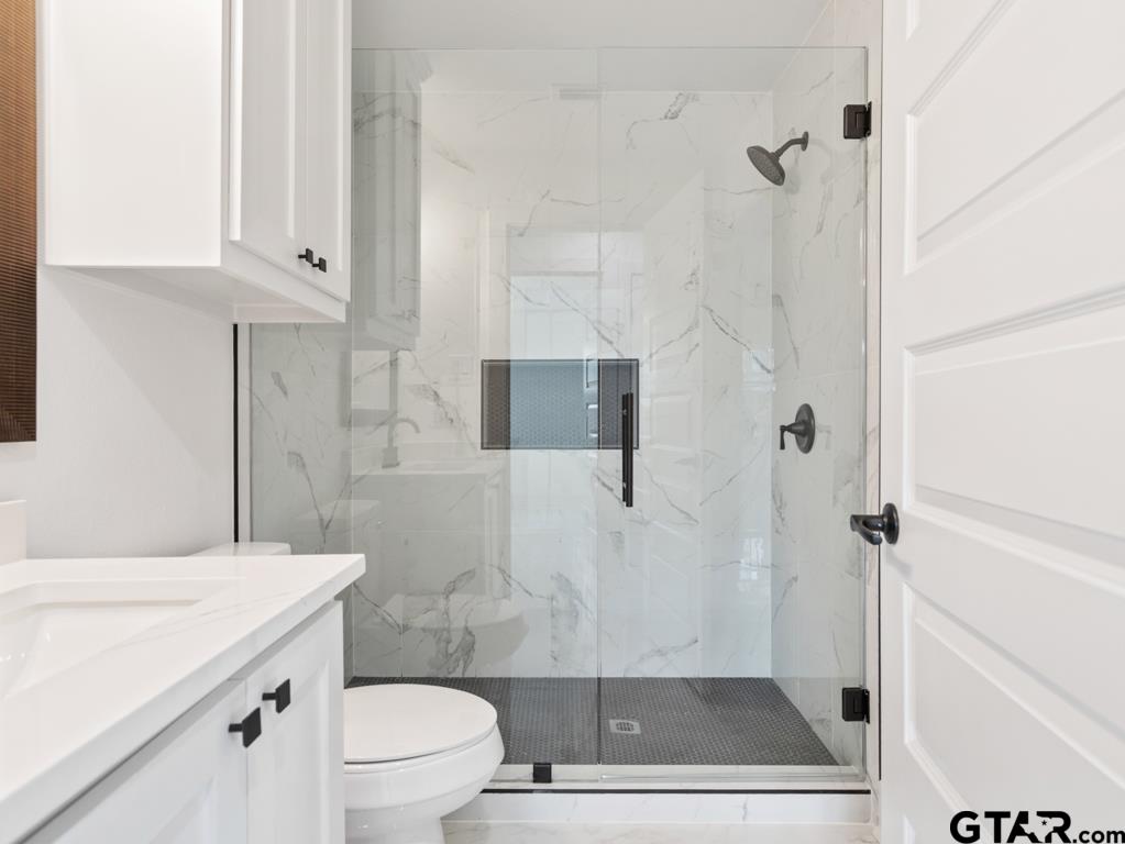 1608 Austin Drive Tyler, TX 75701 - Photo 20 of 36 a bathroom with a sink a toilet and shower