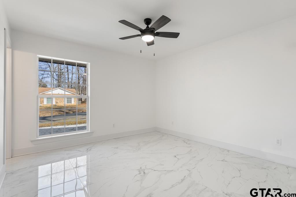 1608 Austin Drive Tyler, TX 75701 - Photo 23 of 36 an empty room with windows and ceiling fan