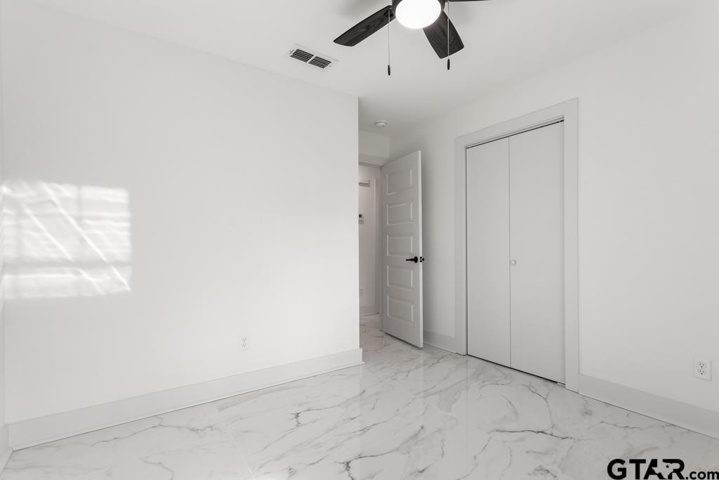 1608 Austin Drive Tyler, TX 75701 - Photo 27 of 36 an empty room with view of ceiling fan