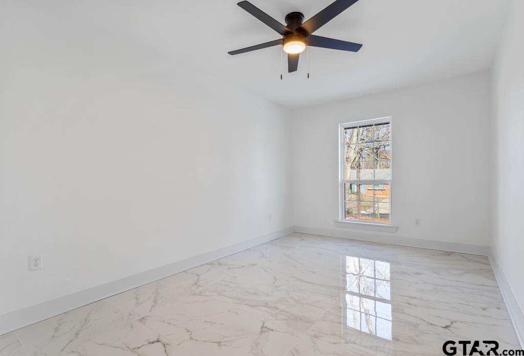 1608 Austin Drive Tyler, TX 75701 - Photo 28 of 36 an empty room with windows and fan