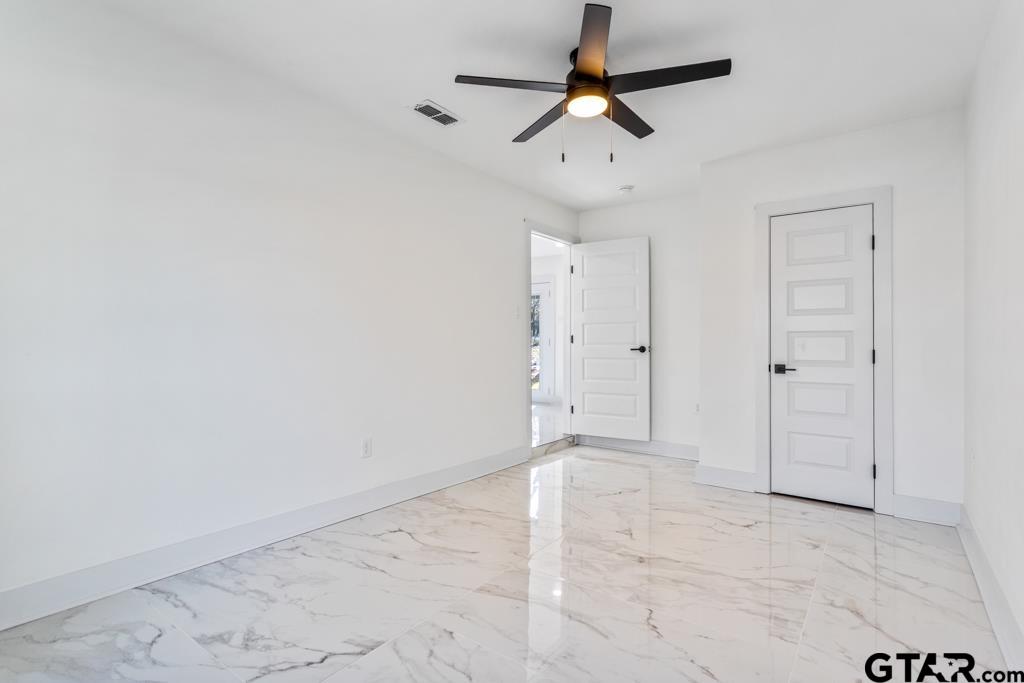1608 Austin Drive Tyler, TX 75701 - Photo 29 of 36 en empty room with ceiling fan and shower