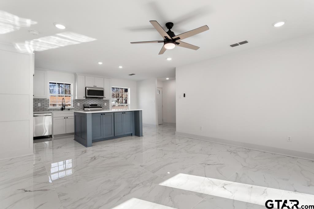 1608 Austin Drive Tyler, TX 75701 - Photo 8 of 36 a kitchen with a sink stainless steel appliances and cabinets