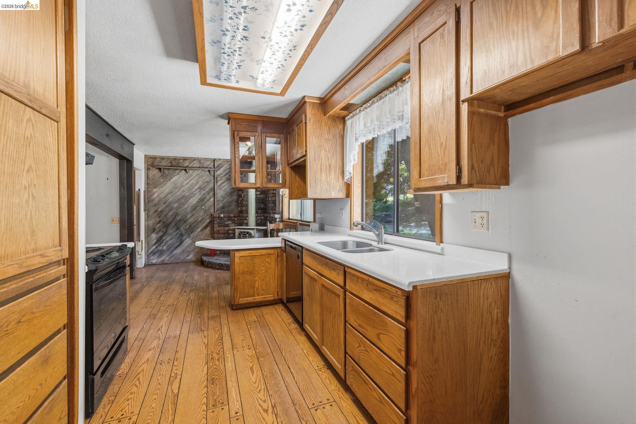 22401 South Fork Road Sonora, CA 95370 - Photo 13 of 34 Kitchen featuring wood-finish flooring and solid wood cabinetry