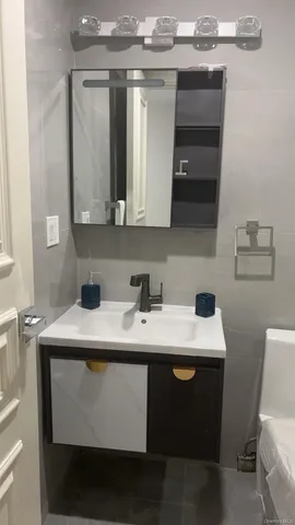 a utility room with a sink and a mirror